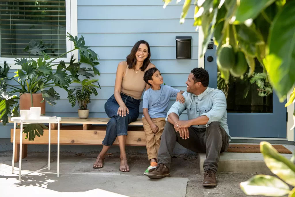 family earning $3000 with an ADU in california posing for a photo outside their ADU for YDS Architects